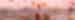 Young woman on a background of flying balloons at sunrise in Cappadocia with a pink sky