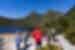 Group standing on the shores of Lake St. Clair looking up Cradle Mountain in Tasmania