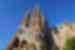 Grand view of the Sagrada Familia Church towers against a blue sky backdrop