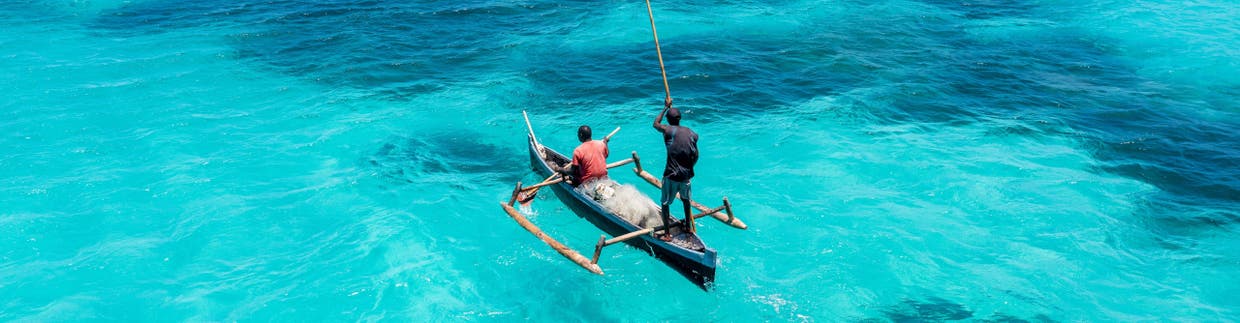 Intrepid Travel Africa Shutterstock 2284070155 2560 Fishermen With A Small Boat In The Coast Of Mozambique In Cabo Delgado With A Aerial Drone View With Tropical Blue Clear Waters ?width=1240&crop=2560%2C667%2Coffset X50%2Coffset Y50&quality=75&format=pjpg&auto=webp